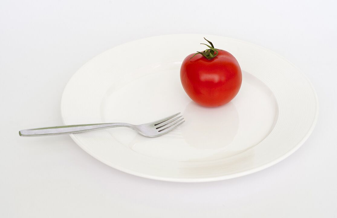 tomatoes with fork on plate